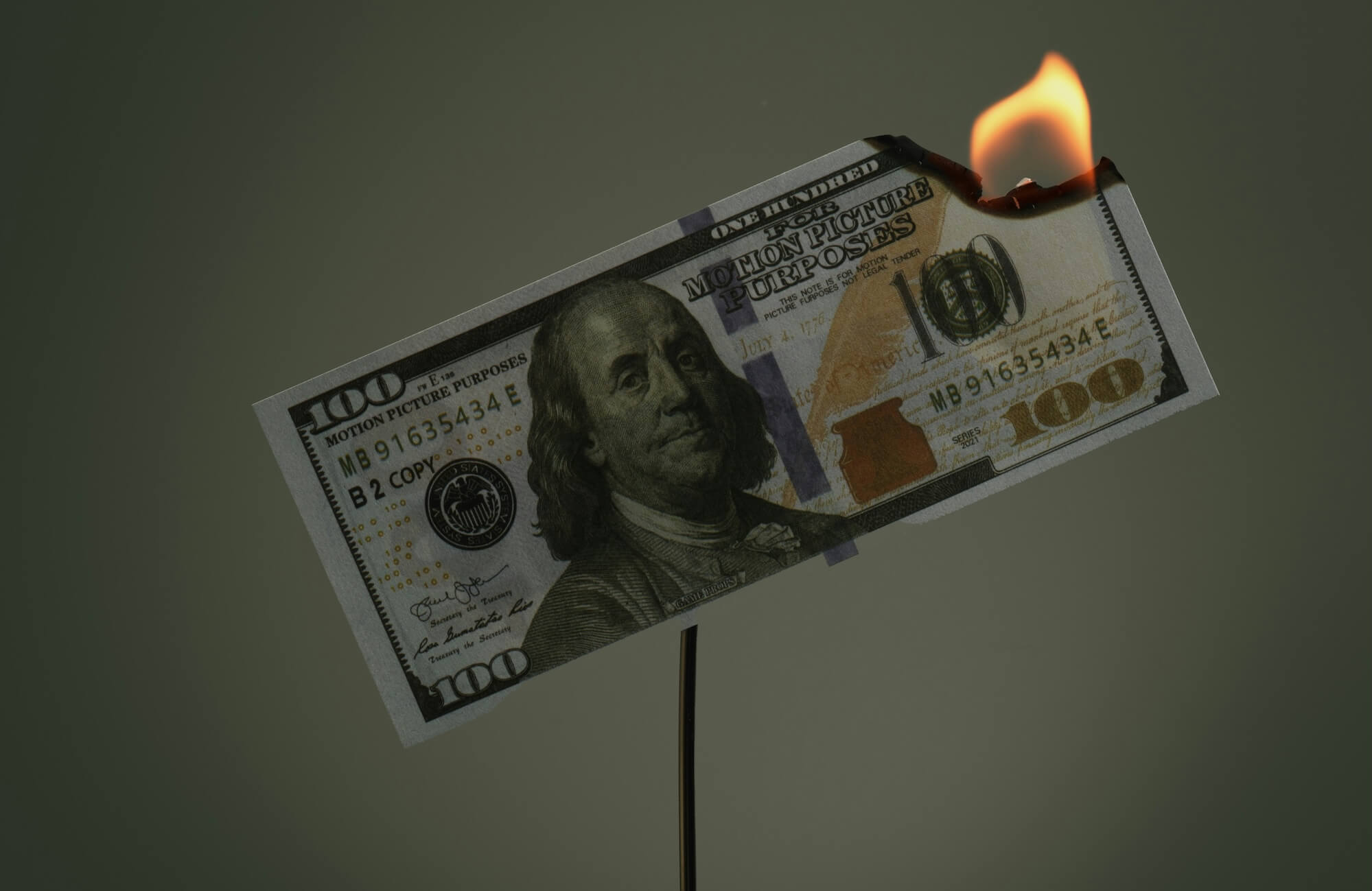 A $100 bill burns.